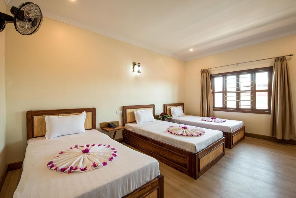 Postel nebo postele na pokoji v ubytování Seng Hout Hotel