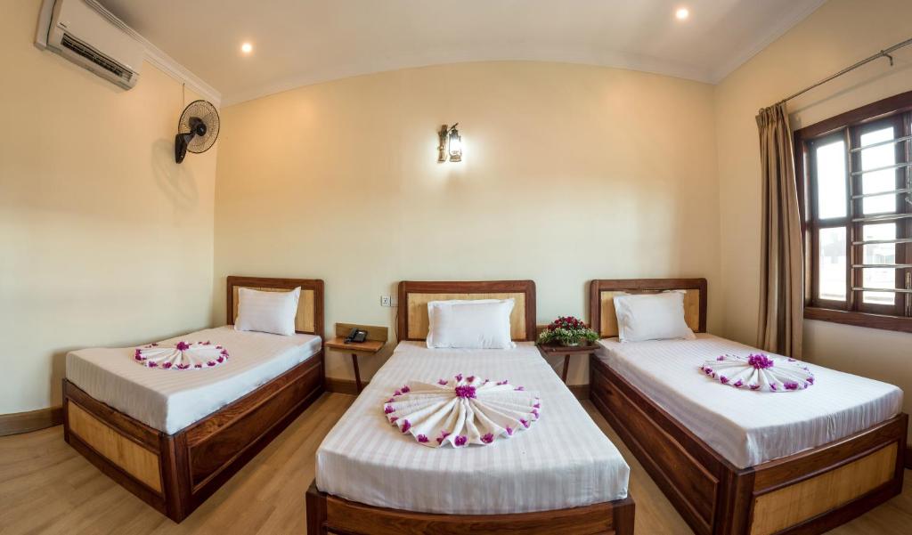 Postel nebo postele na pokoji v ubytování Seng Hout Hotel