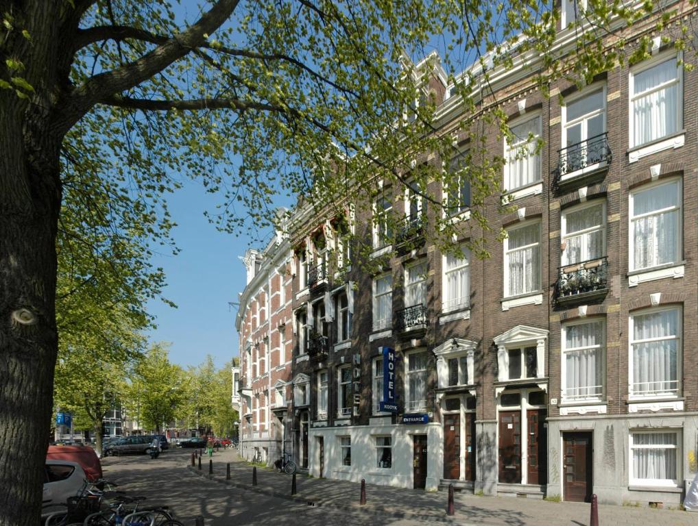 un gran edificio de ladrillo en una calle de la ciudad en Family Hotel Kooyk, en Ámsterdam