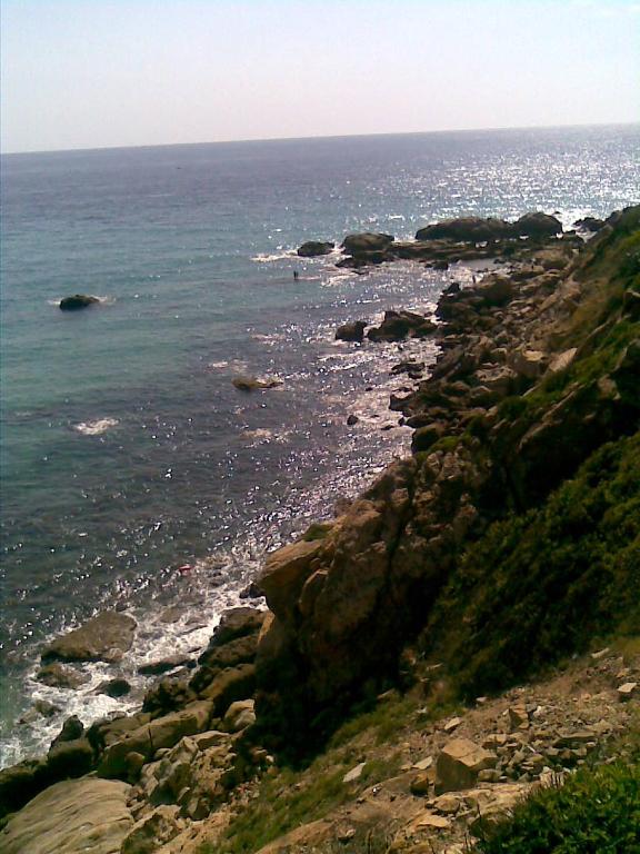 a view of the ocean from a rocky shore at Casas El Suspiro in Zahora
