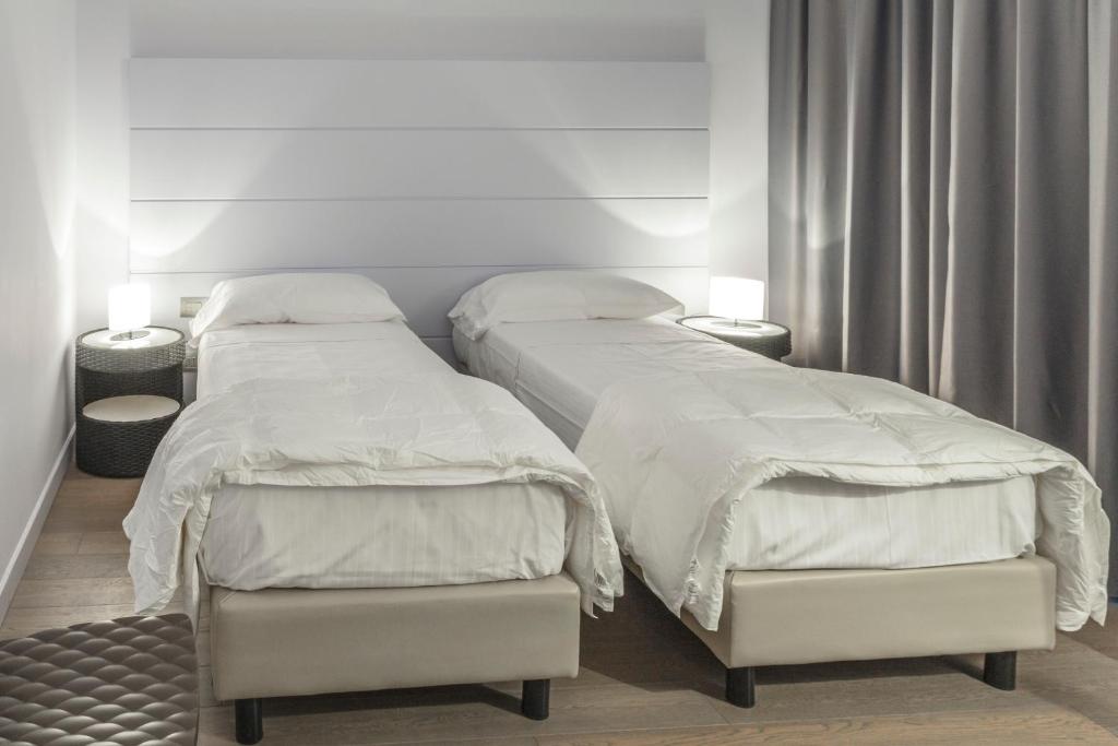 Postel nebo postele na pokoji v ubytování Tag Hotel