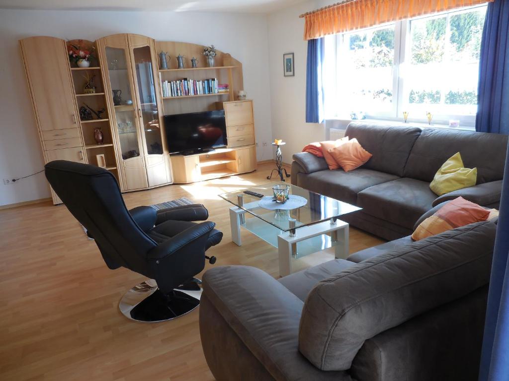 a living room with a couch and a chair and a table at Ferienhaus Wellisch in Lohberg