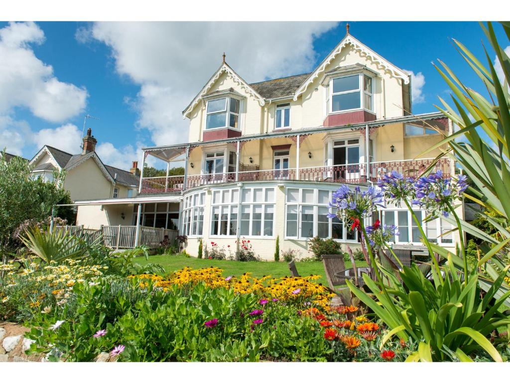 a large house with flowers in the yard at The Clifton in Shanklin