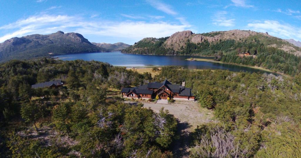 an aerial view of a house in the middle of a lake at Laguna Larga Lodge in Parque Nacional Los Alerces
