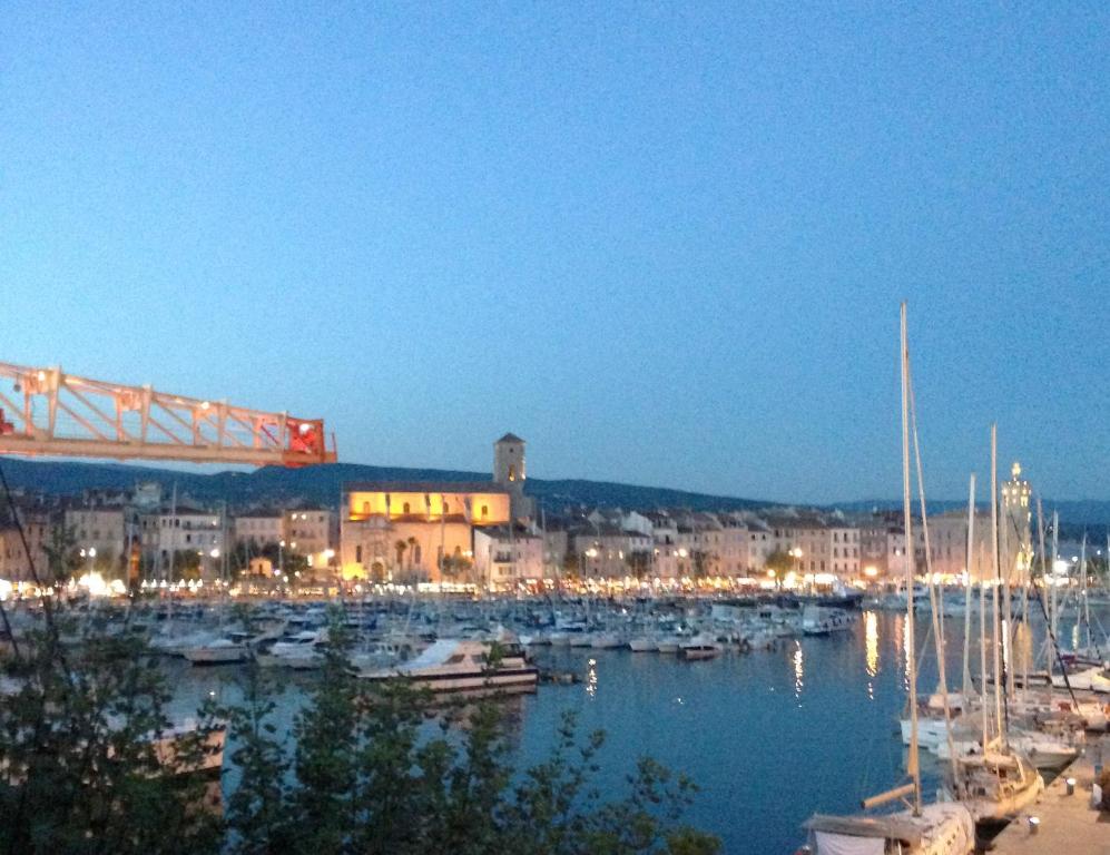 a harbor with boats in the water at night at Accostage Vieux-Port - Appartements & Parking en option in La Ciotat