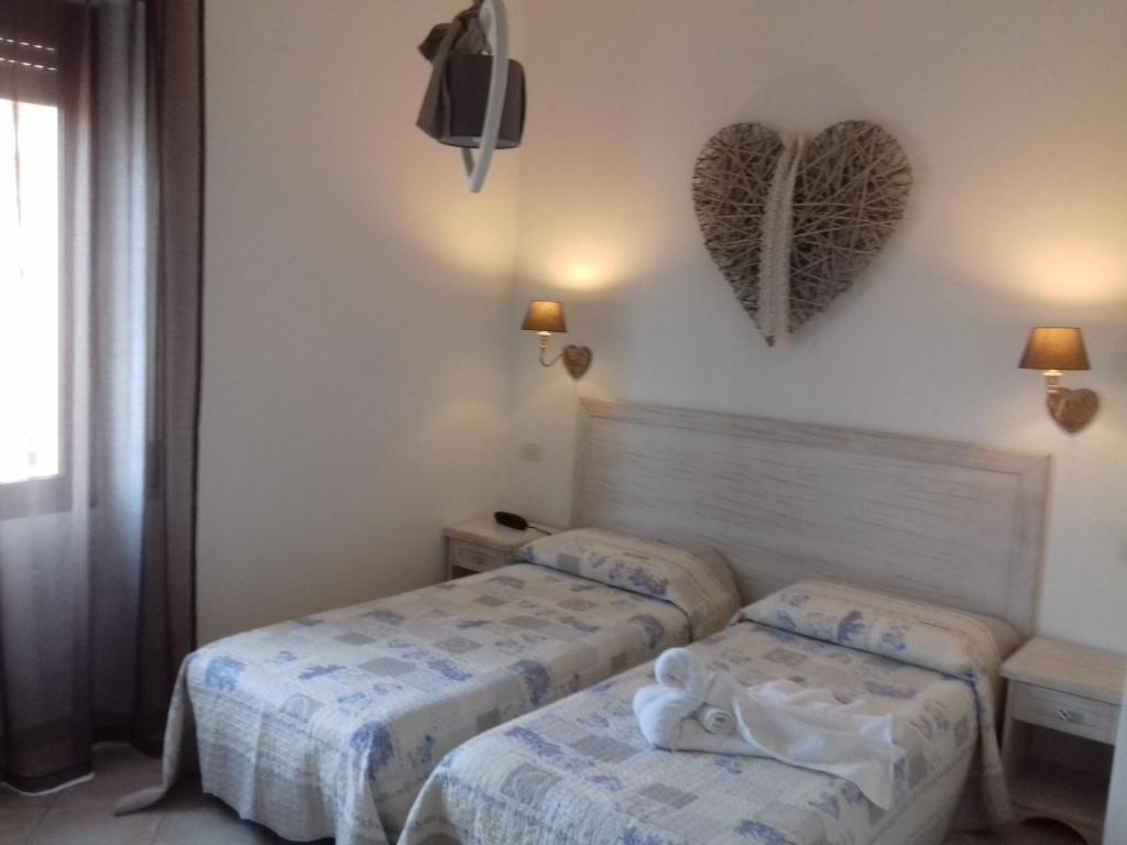 Postel nebo postele na pokoji v ubytování Hotel Tabby