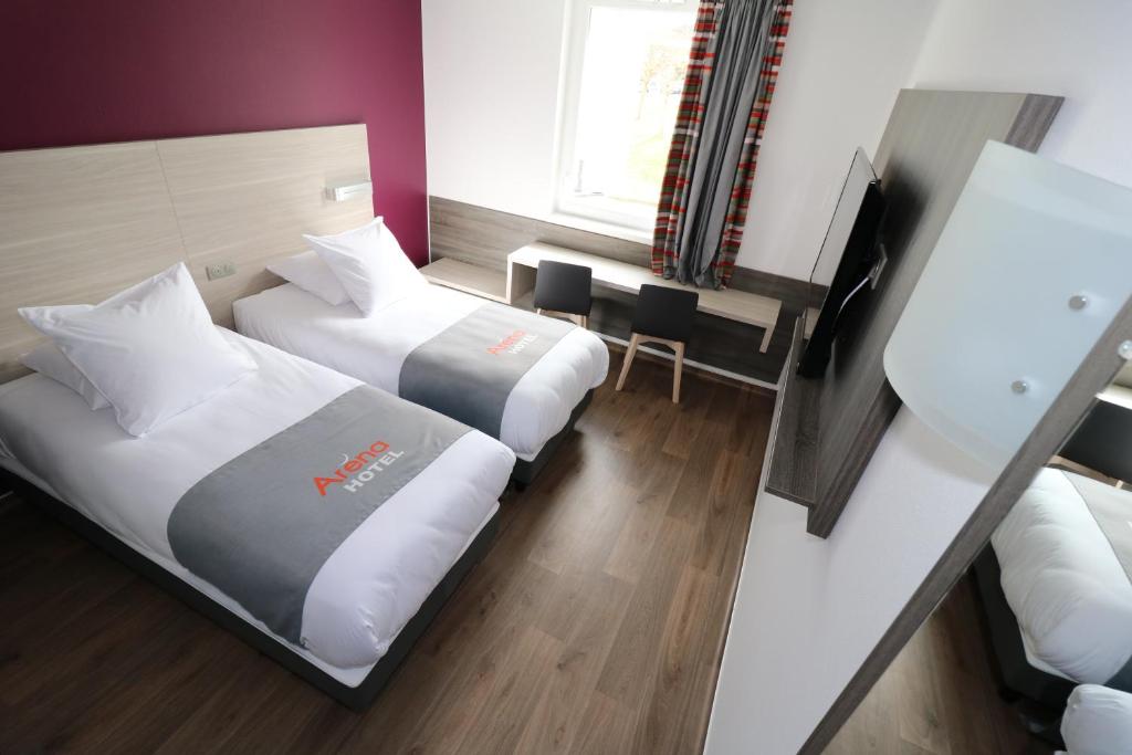 Postel nebo postele na pokoji v ubytování Hotel Arena Toulouse