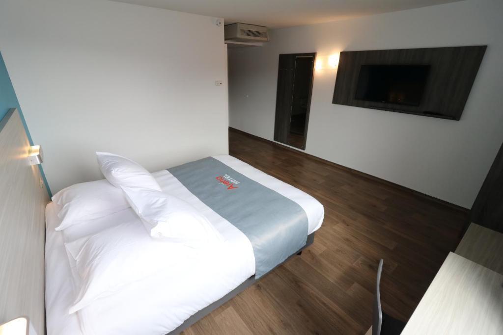 Postel nebo postele na pokoji v ubytování Hotel Arena Toulouse