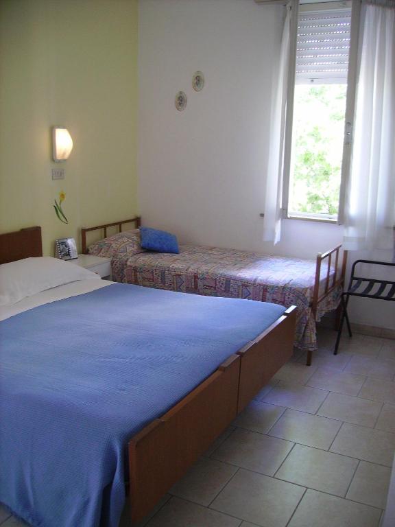 Postel nebo postele na pokoji v ubytování Albergo Maria Gabriella