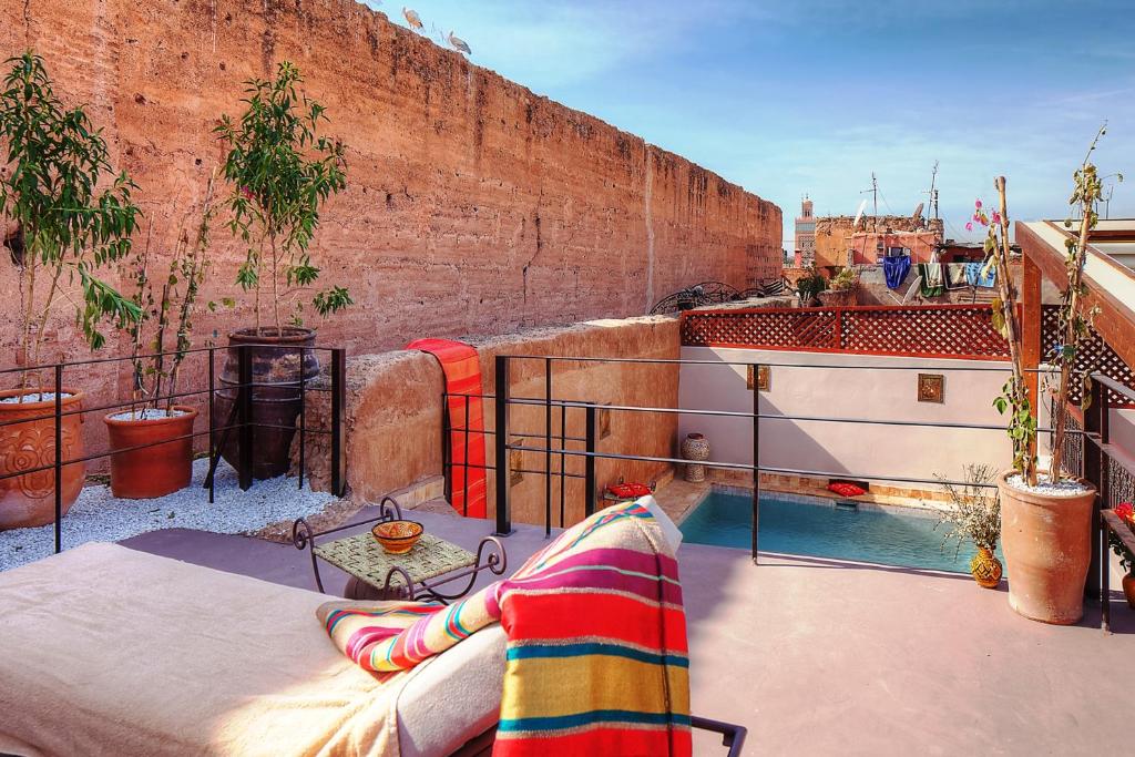 a person laying on the ledge of a balcony at Riad Carina in Marrakech