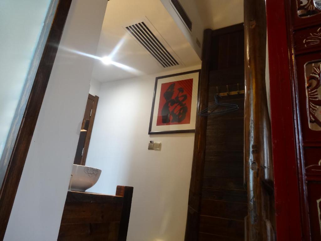 a hallway with a staircase and a painting on the wall at 张家界畔山驿栈 in Zhangjiajie
