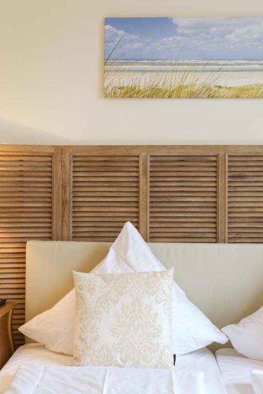 Postel nebo postele na pokoji v ubytování Das Frühstückshotel Sankt Peter-Ording