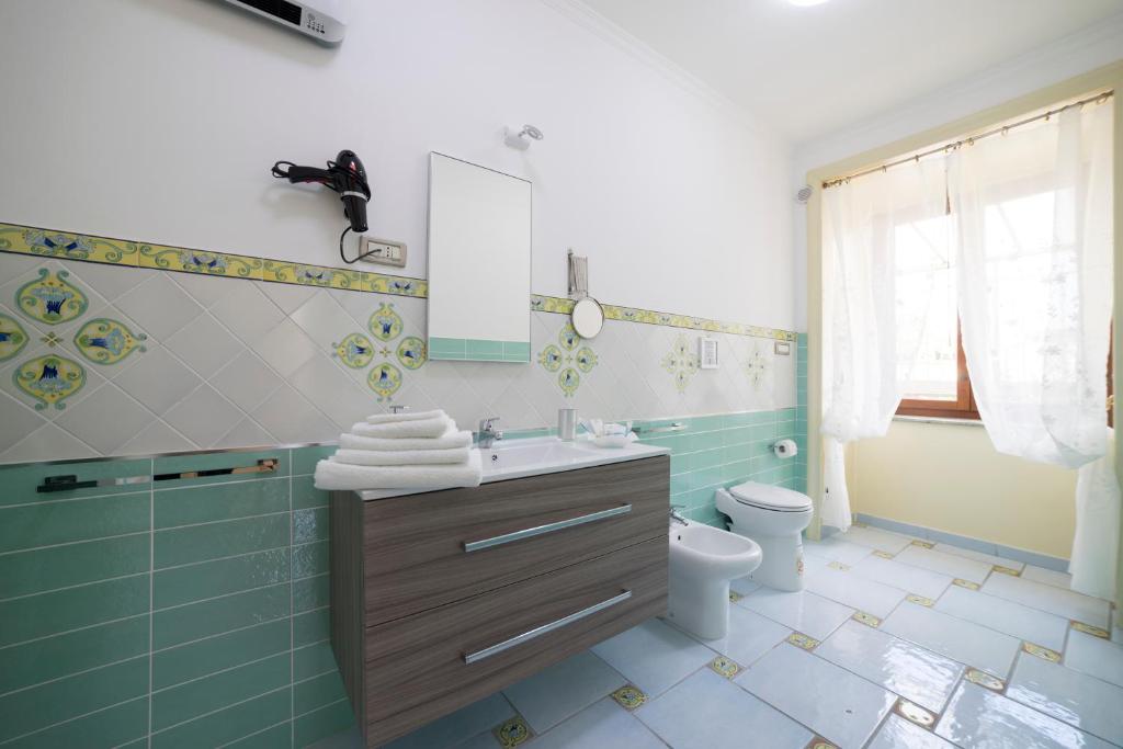 a bathroom with a sink and a toilet at B&B 'O Sole Mio! in Naples