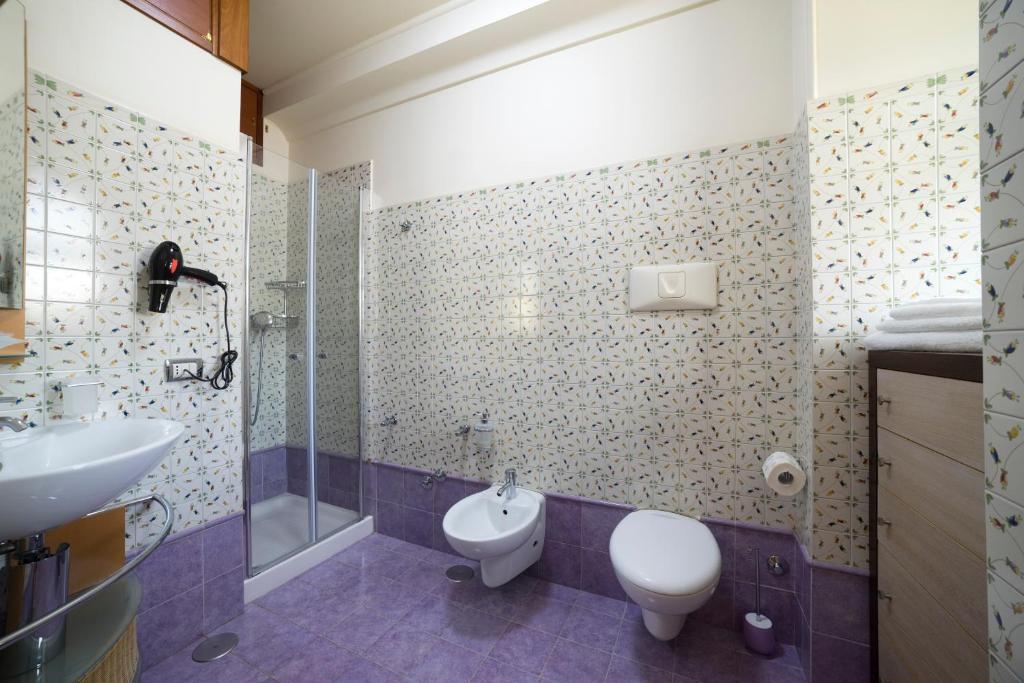 a bathroom with a toilet and a sink and a shower at B&B 'O Sole Mio! in Naples