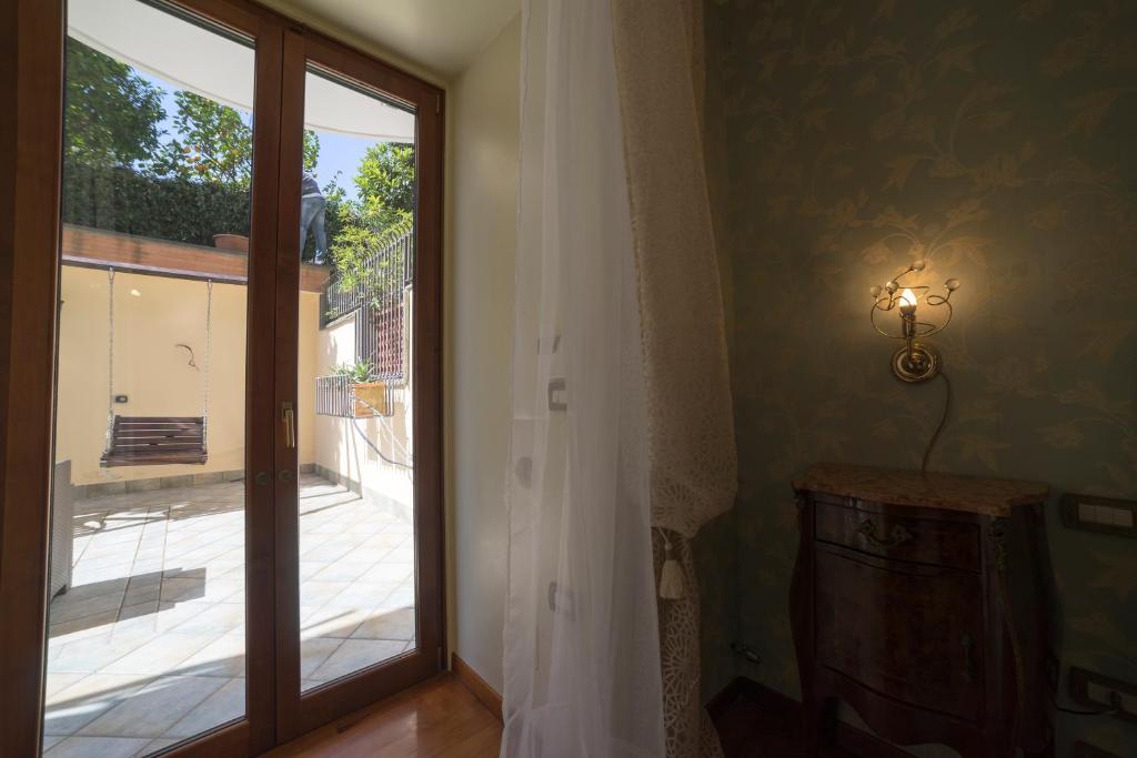 a room with a sliding glass door with a view of a courtyard at B&B 'O Sole Mio! in Naples