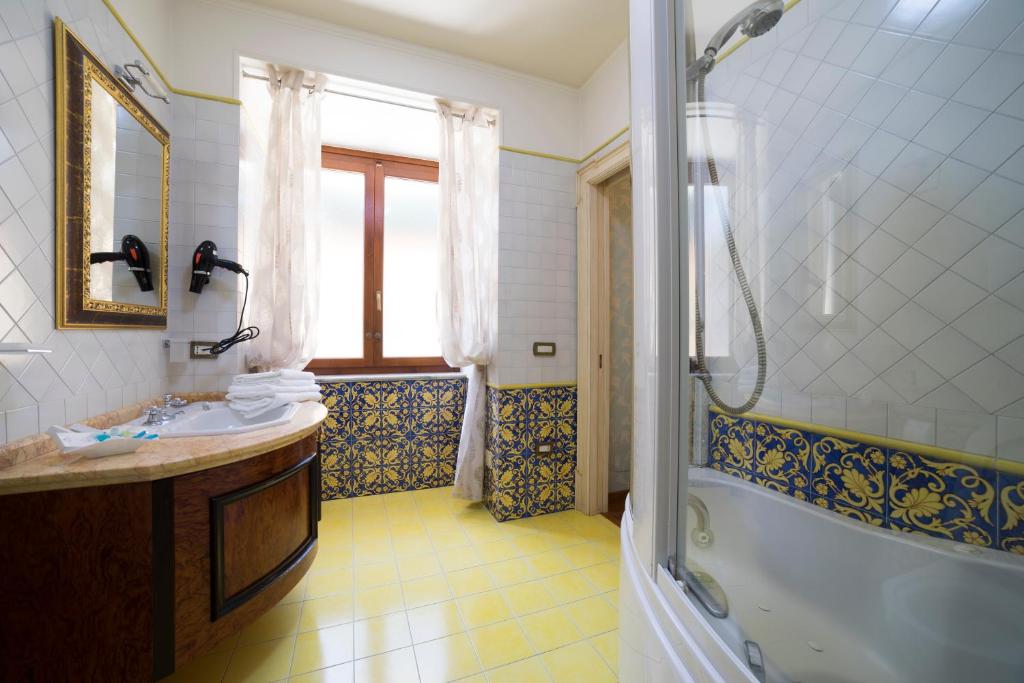a bathroom with a tub and a sink and a shower at B&B 'O Sole Mio! in Naples