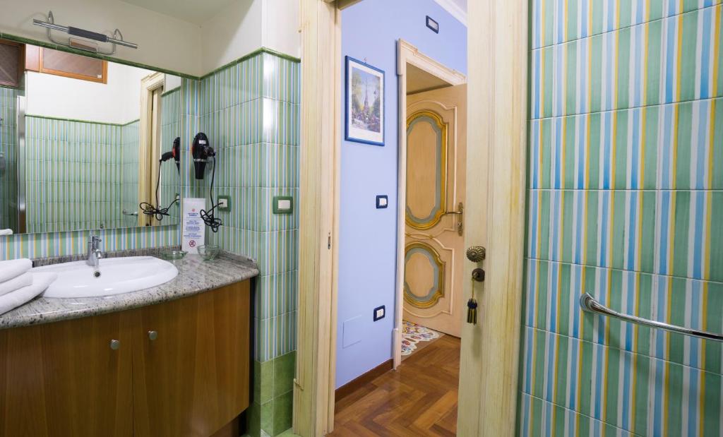 a bathroom with a sink and a mirror at B&B 'O Sole Mio! in Naples