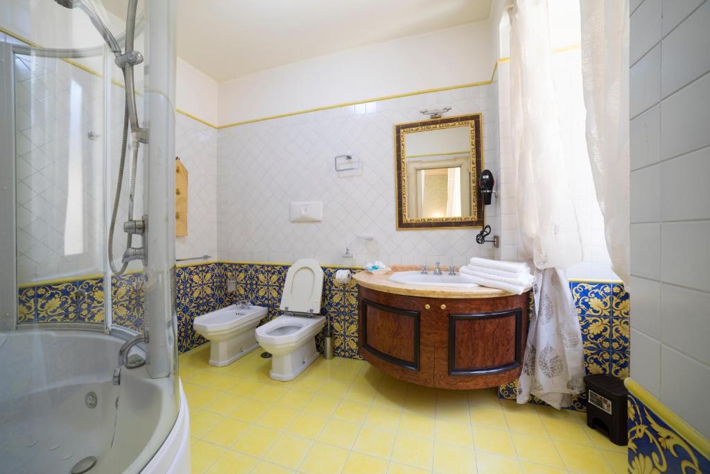 a bathroom with a tub and a toilet and a sink at B&B 'O Sole Mio! in Naples