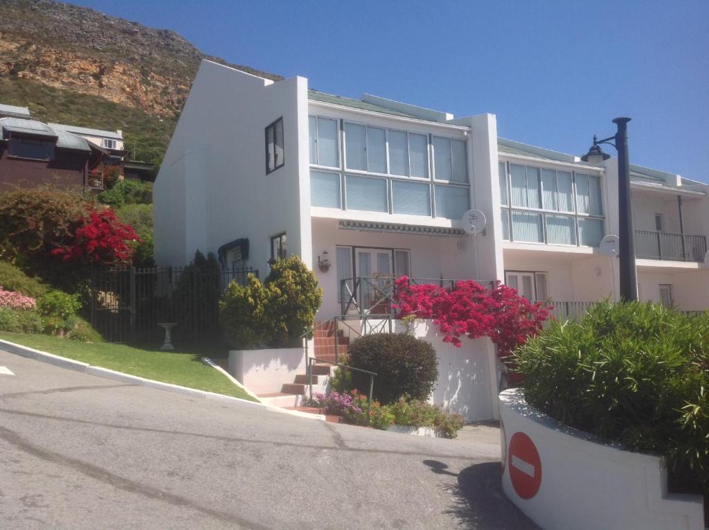 a white building with flowers in front of it at No. 1 Living Waters in Simonʼs Town