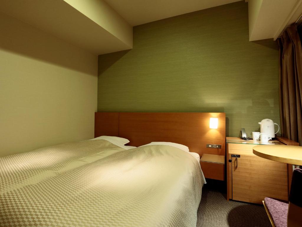 Postel nebo postele na pokoji v ubytování Candeo Hotels Handa