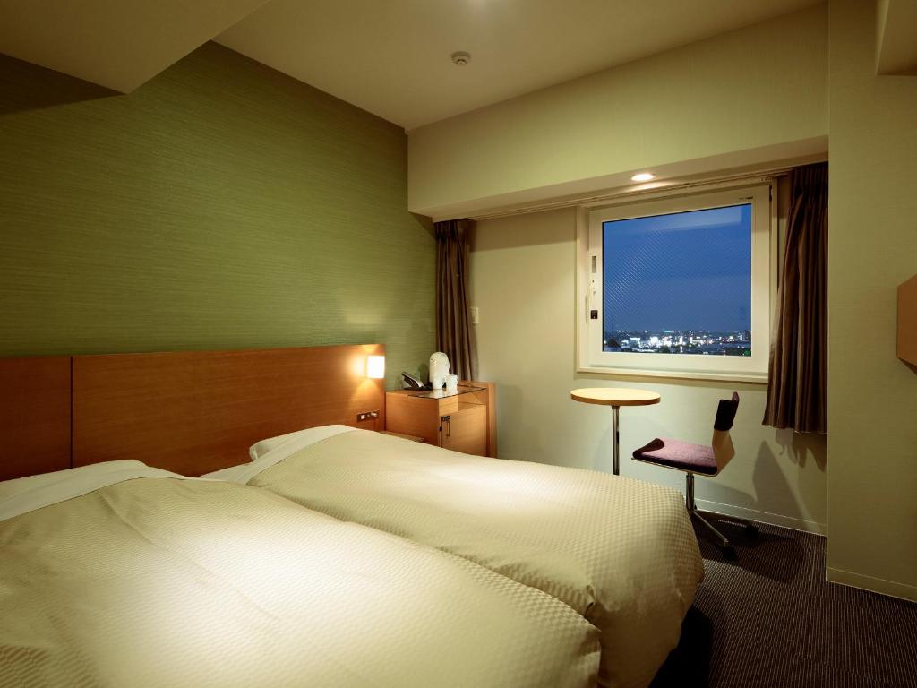 Postel nebo postele na pokoji v ubytování Candeo Hotels Handa