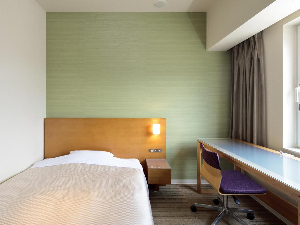 Postel nebo postele na pokoji v ubytování Candeo Hotels Chino