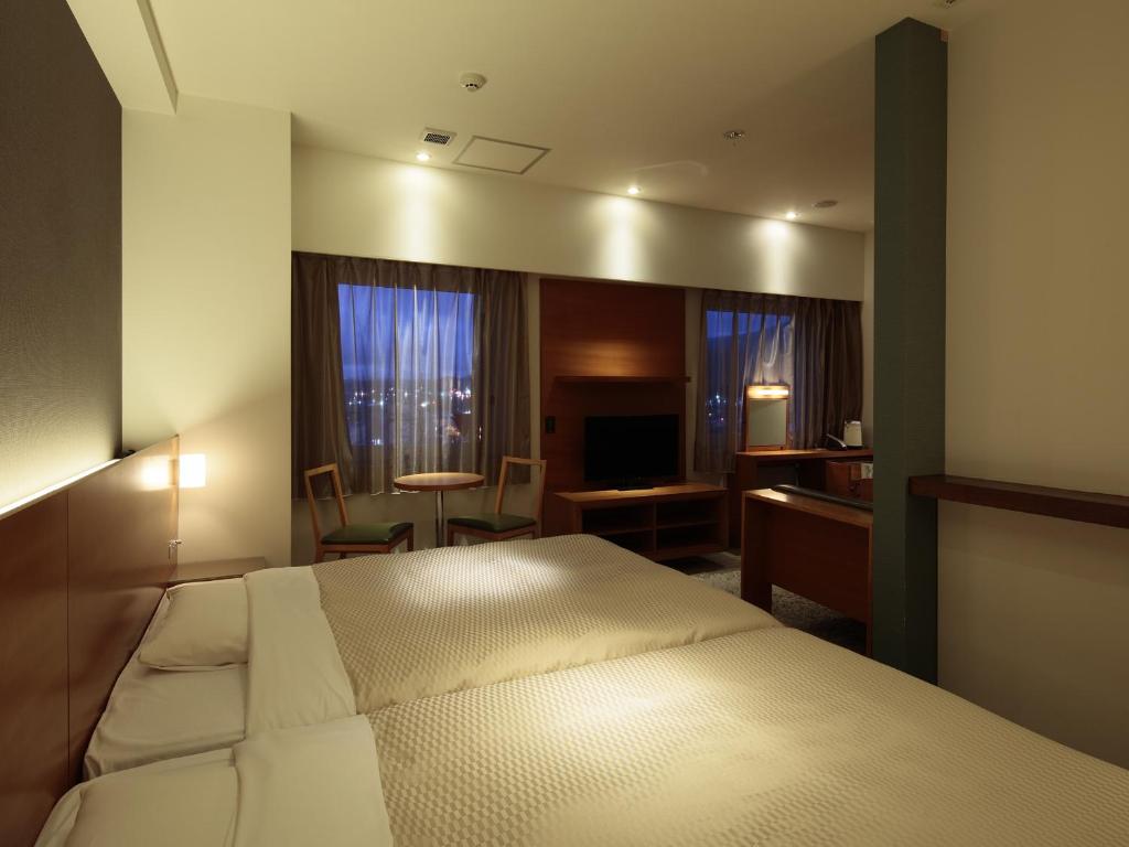 Postel nebo postele na pokoji v ubytování Candeo Hotels Chino