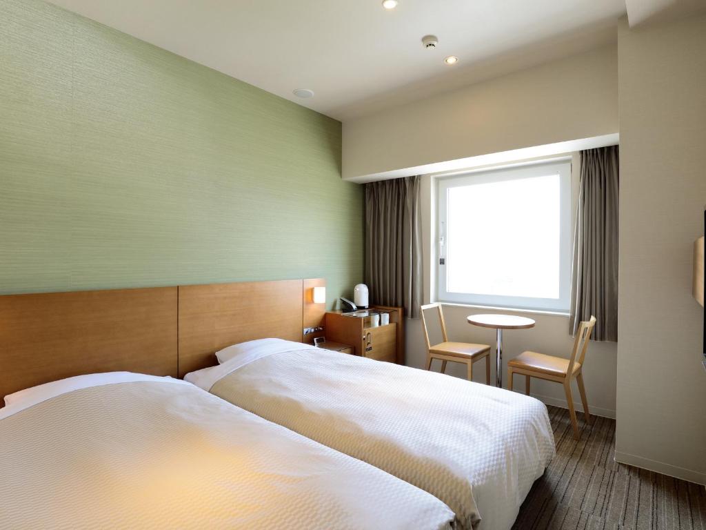 Postel nebo postele na pokoji v ubytování Candeo Hotels Chino