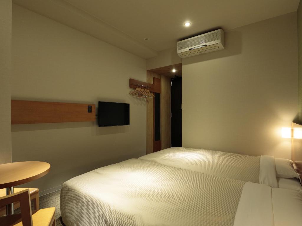 Postel nebo postele na pokoji v ubytování Candeo Hotels Chino