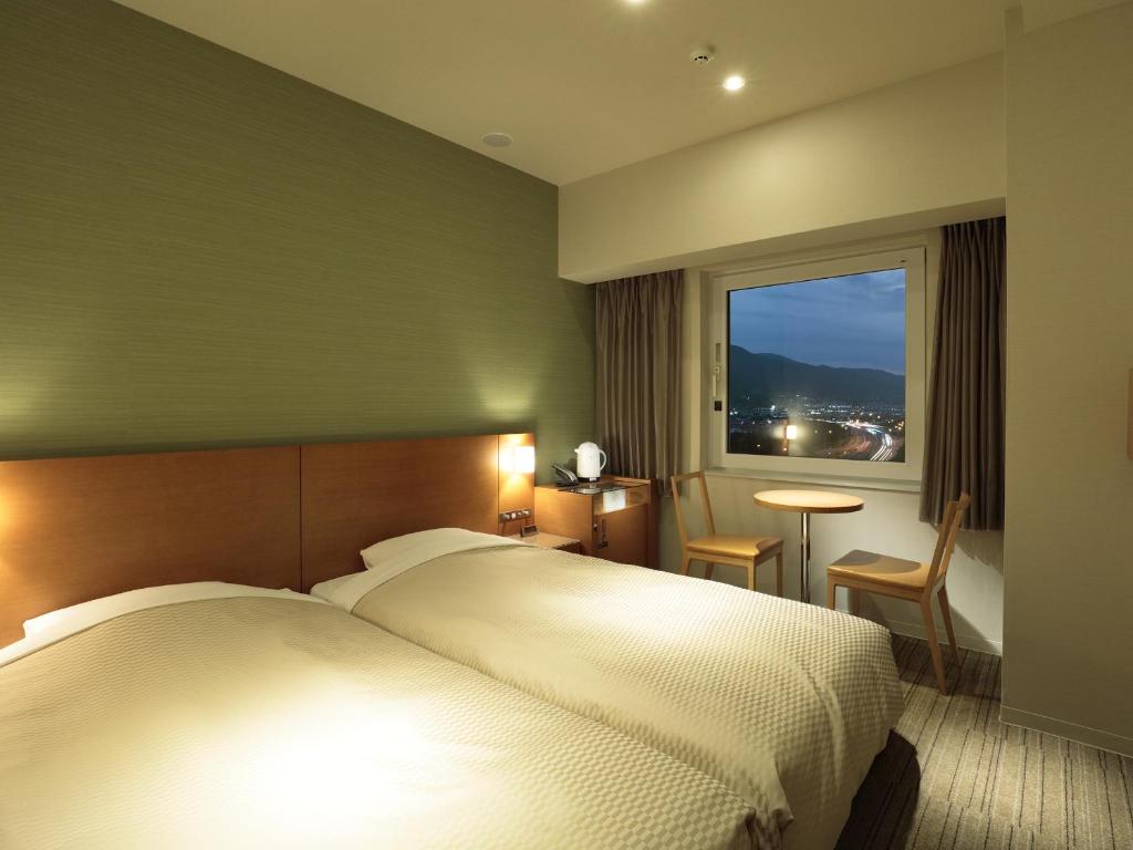 Postel nebo postele na pokoji v ubytování Candeo Hotels Chino