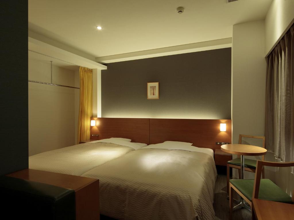 Postel nebo postele na pokoji v ubytování Candeo Hotels Chino