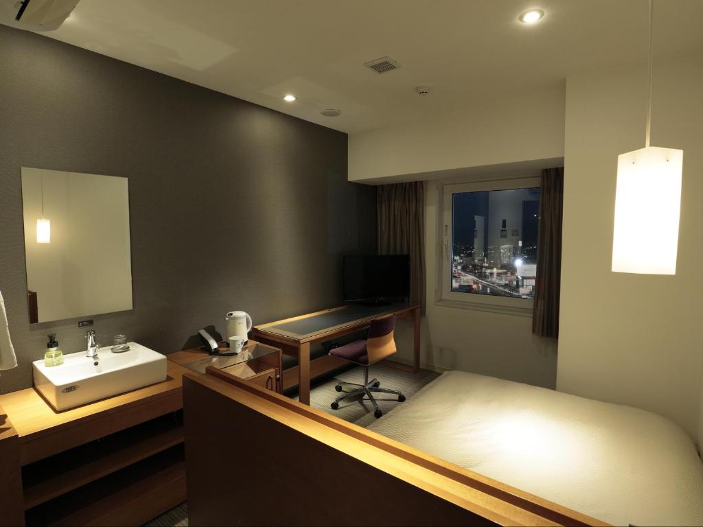 Postel nebo postele na pokoji v ubytování Candeo Hotels Chino