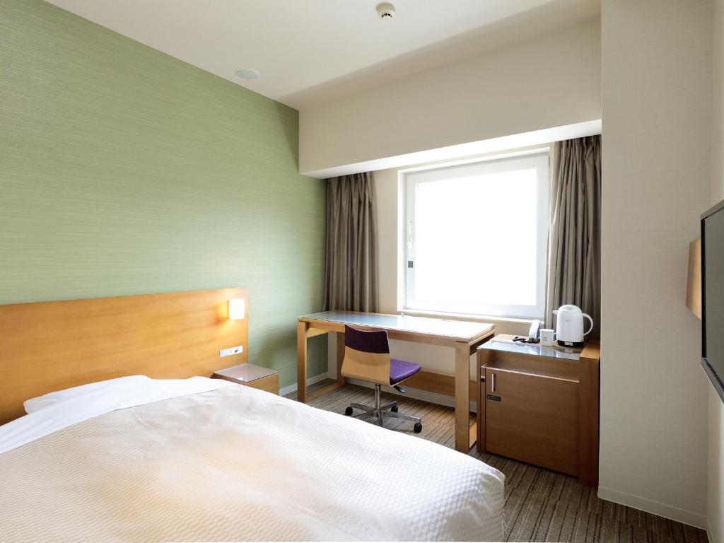 Postel nebo postele na pokoji v ubytování Candeo Hotels Chino