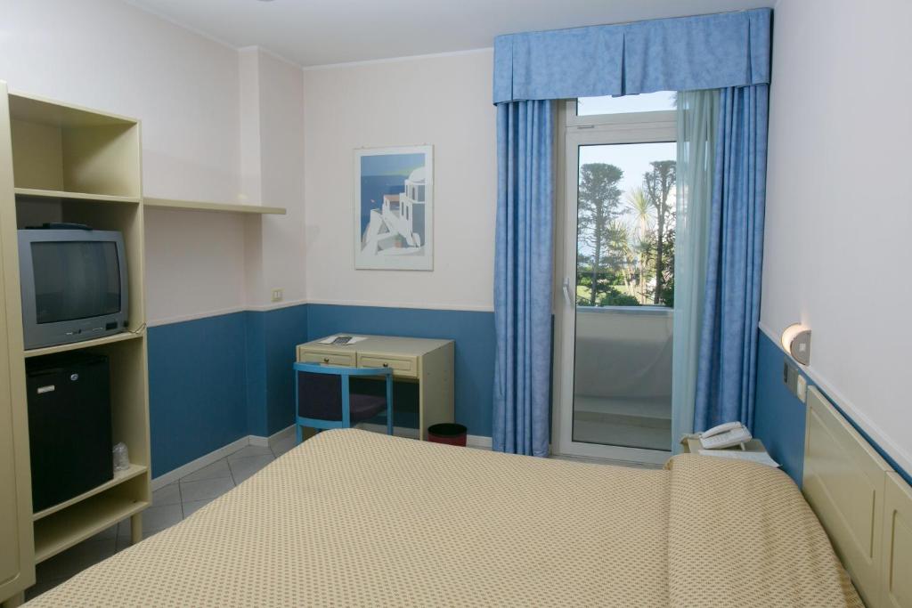 Postel nebo postele na pokoji v ubytování Hotel Salsello