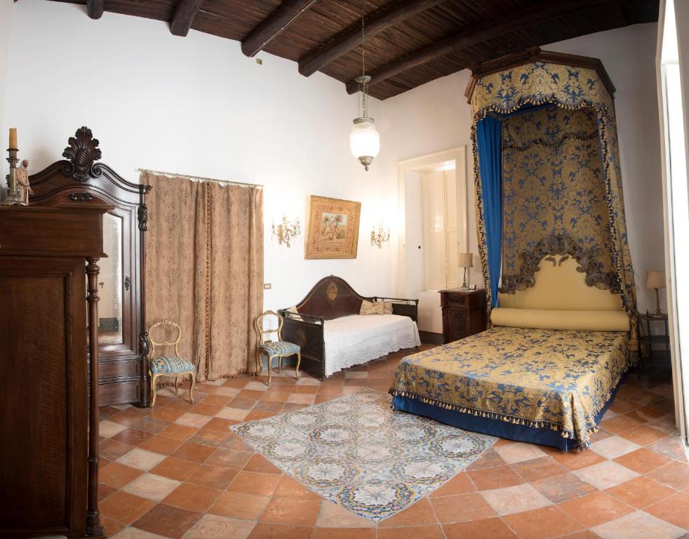 a bedroom with a bed and a couch at Il Teatro Di Nerone in Naples