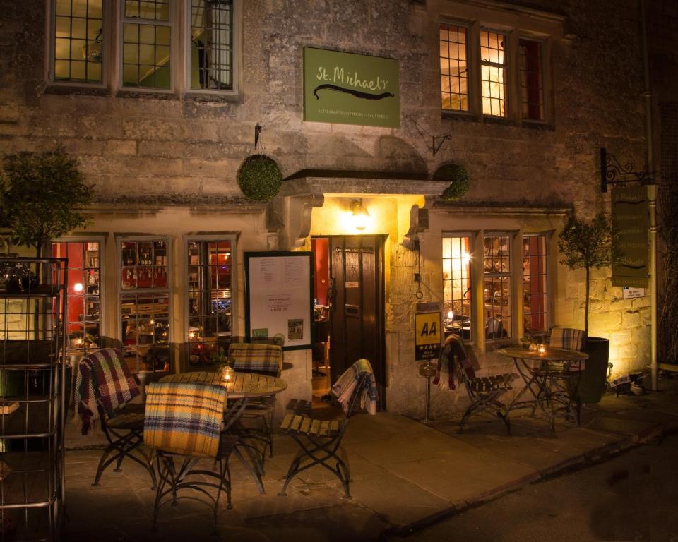 a restaurant with tables and chairs in front of a building at St.Michaels Bistro in Painswick