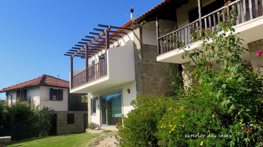 an external view of a house with a balcony at Casa do Mercador in Real