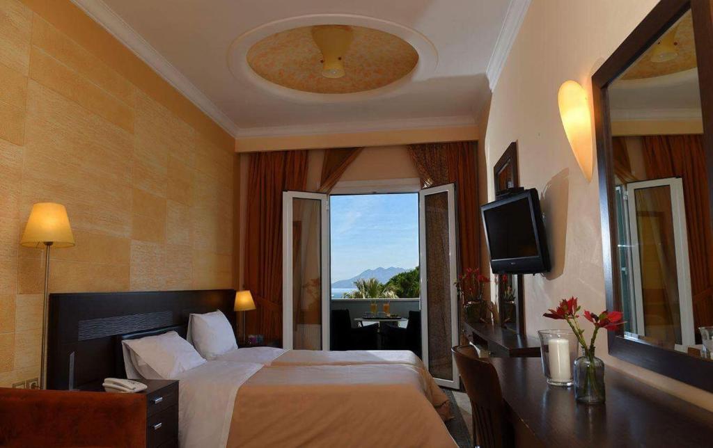 Postel nebo postele na pokoji v ubytování Aktis Hotel