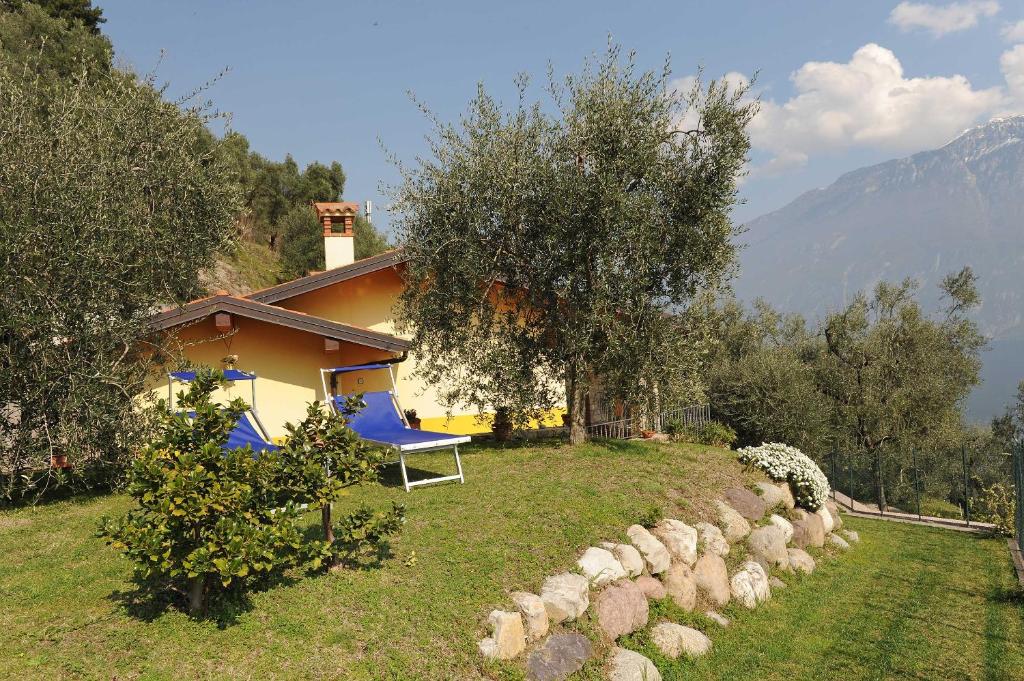 a house with a blue chair in a yard at Appartamento Ai Ruck in Limone sul Garda