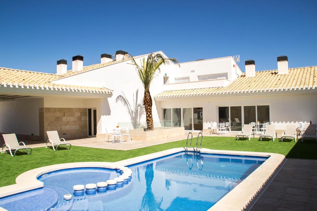 a villa with a swimming pool and a house at Casa Boquera in Carche