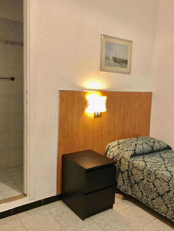 Postel nebo postele na pokoji v ubytování Hotel Fiorenza