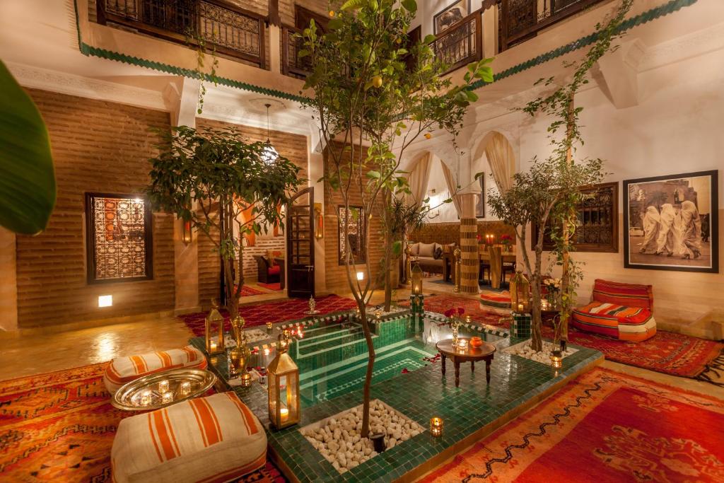 a living room with a pool in the middle of the room at Riad Dar Yema in Marrakesh