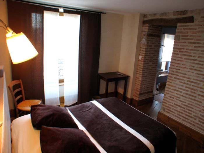 Postel nebo postele na pokoji v ubytování L'Ancien Presbytère