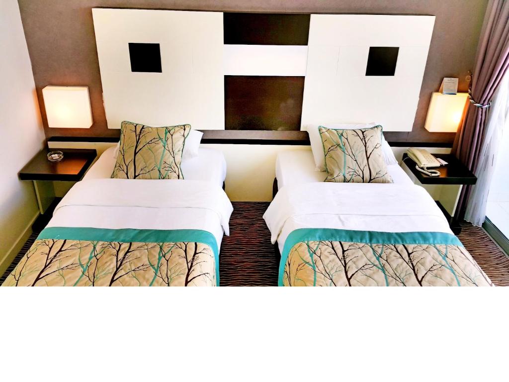 Postel nebo postele na pokoji v ubytování Blue Garden Hotel