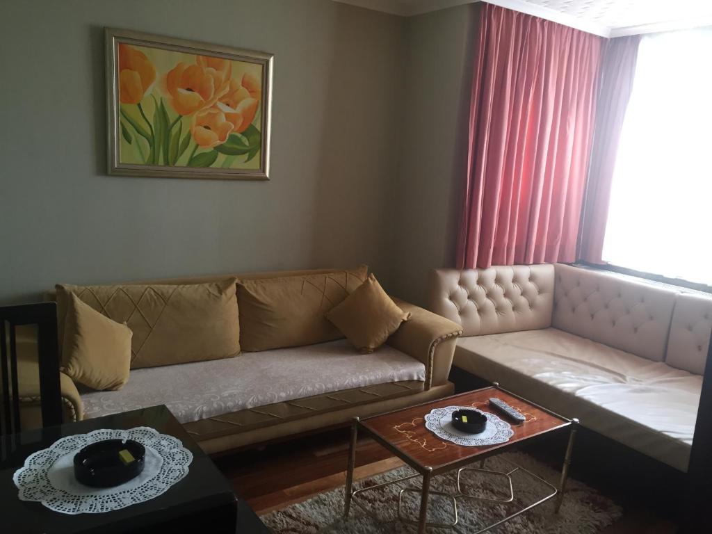 a living room with a couch and a table at Ulasan Hotel Caravan Camping in Ankara