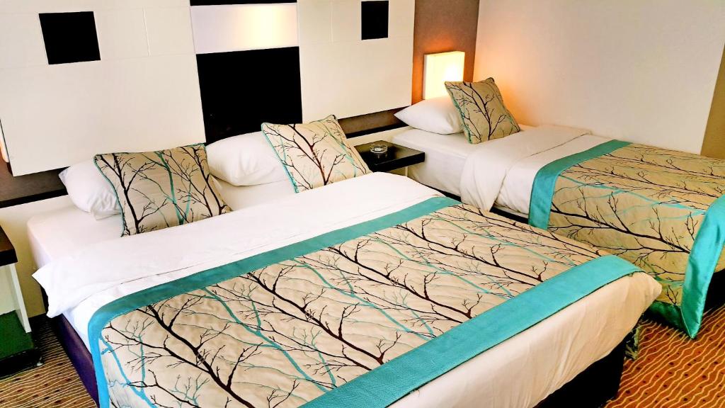 Postel nebo postele na pokoji v ubytování Blue Garden Hotel