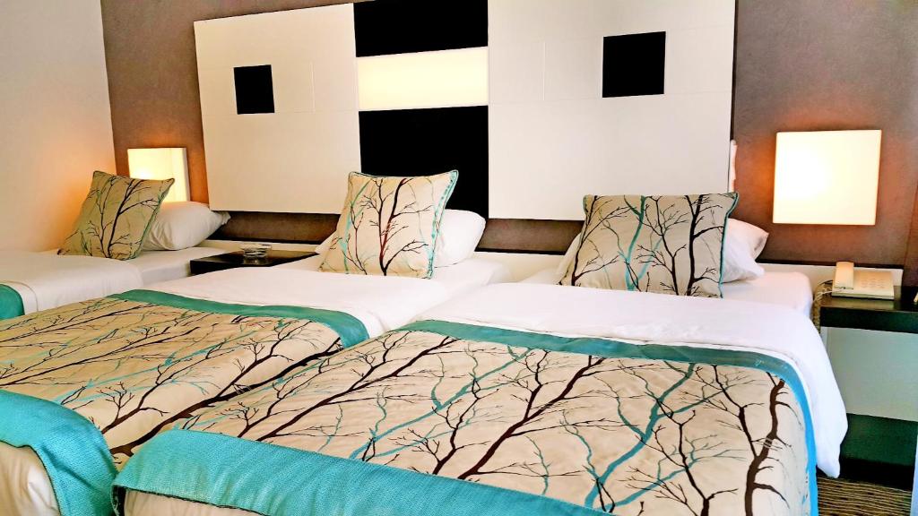 Postel nebo postele na pokoji v ubytování Blue Garden Hotel