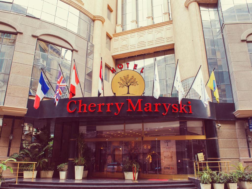 a store front of a shopping center with flags at Cherry Maryski Hotel in Alexandria