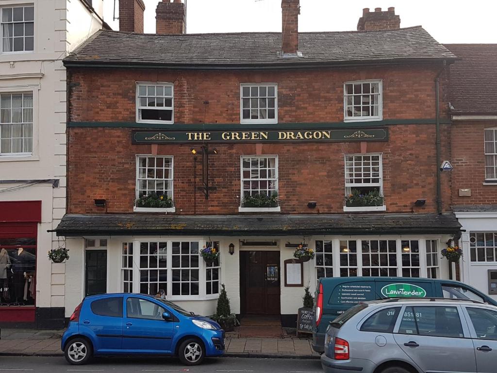 a blue car parked in front of a brick building at The Green Dragon in Marlborough