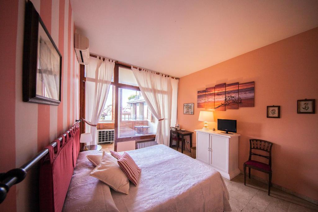a bedroom with a bed and a window and a desk at A Teatro in Florence
